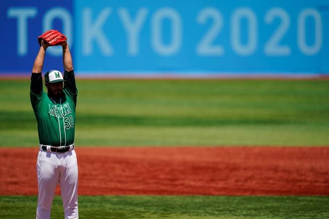 Mexico's Manuel Barrera stretches while pitching during a baseball game against Israel at Yokohama Baseball Stadium during the 2020 Summer Olympics, Sunday, Aug. 1, 2021, in Yokohama, Japan. (AP Photo/Matt Slocum)