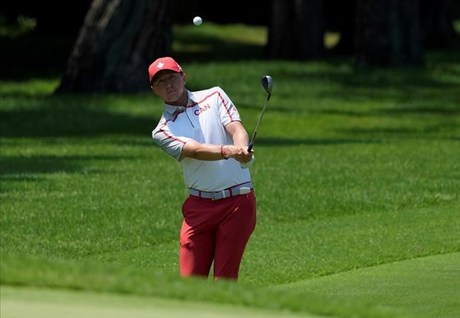 Mackenzie Hughes of Canada chips onto the 5th green during the final round of the men's golf event at the 2020 Summer Olympics on Sunday, Aug. 1, 2021, in Kawagoe, Japan. THE CANADIAN PRESS/AP, Andy Wong