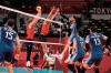 Argentina's Facundo Conte spikes a ball past Maxwell Holt, #12, and Taylor Sander, of the United States, during a men's volleyball preliminary round pool B match, at the 2020 Summer Olympics, early Monday, Aug. 2, 2021, in Tokyo, Japan. (AP Photo/Manu Fernandez)