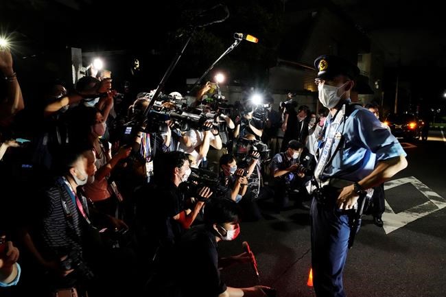 Journalists gather at the Poland Embassy to report on Belarusian athlete Krystsina Tsimanouskaya after she visited the embassy in Tokyo, Japan, Monday, Aug. 2, 2021. Tsimanouskaya, a Belarusian Olympic sprinter plans to seek asylum in Poland after alleging that officials tried to force her home, where she feared for her safety, an activist group said Monday. (AP Photo/Eugene Hoshiko)