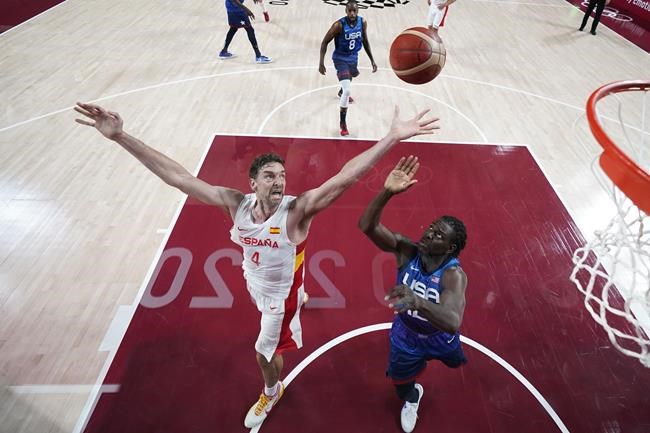 Spain's Pau Gasol (4) fights for a rebound with United States' Jrue Holiday, right, during a men's basketball quarterfinal round game at the 2020 Summer Olympics, Tuesday, Aug. 3, 2021, in Saitama, Japan. (AP Photo/Charlie Neibergall, Pool)