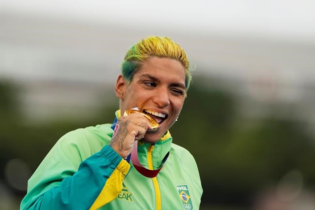 Ana Marcela Cunha, of Brazil, poses with her gold medal after winning the women's marathon swimming event at the 2020 Summer Olympics, Wednesday, Aug. 4, 2021, in Tokyo. (AP Photo/David Goldman)