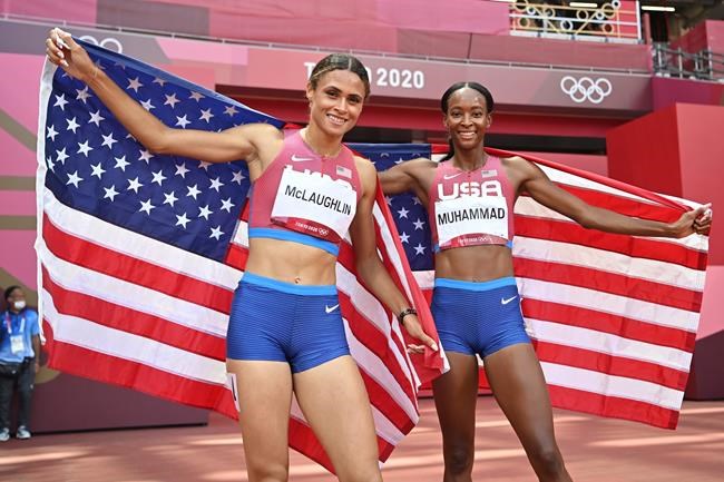 Sydney Mclaughlin, left, and Dalilah Muhammad, both of the United States, celebrate after finishing first and second respectively in the women's 400m hurdles final during the 2020 Summer Olympics on Wednesday, Aug. 4, 2021, in Tokyo, Japan . (Andrej ISAKOVIC / POOL / AFP)