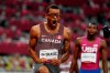 Canada's Andre De Grasse reacts after racing to a gold medal as American Erriyon Knighton looks on in the Men's 200m final during the Tokyo Olympics in Tokyo, Japan on Wednesday, August 4, 2021. After two days without any medals at the Tokyo Olympics, Andre De Grasse got Canada back on the board with the greatest run of his stellar career. THE CANADIAN PRESS/Frank Gunn