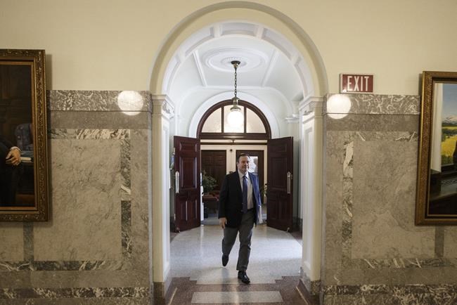 Alberta Premier Jason Kenney makes his way to the chamber as the Alberta Legislature sits through the weekend to pass a series of emergency bills, in Edmonton, Friday, March 20, 2020. The Edmonton Zone Medical Staff Association is calling on the Government of Alberta to reinstate COVID-19 testing, tracing and isolation requirements to control viral spread. THE CANADIAN PRESS/Jason Franson