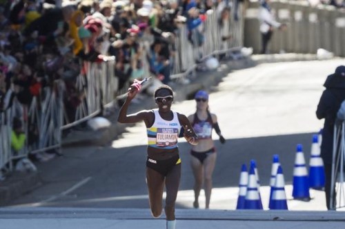 FILE - In this Feb. 29, 2020, file photo, first place finisher Aliphine Tuliamuk leads second place finisher Molly Seidel to the finish in the U.S. Olympic marathon trials in Atlanta. Tuliamuk will have company in Tokyo with her baby, Zoe, allowed to travel with her. The original plan was to start a family after the Tokyo Olympics. But when the Summer Games were postponed by the pandemic, the 32-year-old Tuliamuk and her fiance, Tim Gannon, decided not to wait. (AP Photo/John Amis, File)