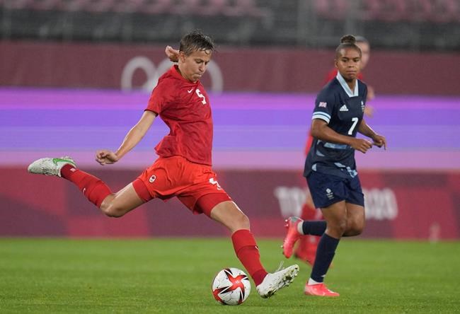 Canada's Quinn, left, prepares to kick the ball during a women's soccer match against Great Britain at the 2020 Summer Olympics, Tuesday, July 27, 2021, in Kashima, Japan. THE CANADIAN PRESS/AP, Fernando Vergara