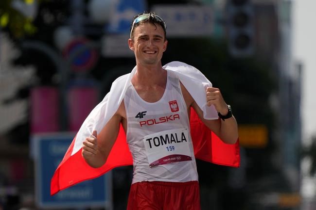 Dawid Tomala, of Poland, celebrates after crossing the finish line first in the men's 50km race walk at the 2020 Summer Olympics, Friday, Aug. 6, 2021, in Sapporo, Japan. (AP Photo/Shuji Kajiyama)