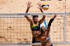 April Ross, right, of the United States, takes a shot as Mariafe Artacho del Solar, of Australia, defends during a women's beach volleyball Gold Medal match at the 2020 Summer Olympics, Friday, Aug. 6, 2021, in Tokyo, Japan. (AP Photo/Petros Giannakouris)
