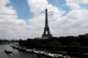 FILE - In this June 8, 2021, file photo, a giant flag flies at the Eiffel Tower during a a test flight in Paris. A giant flag will be flown from the Eiffel Tower like this one on Sunday, Aug. 8, during the Tokyo Olympics closing ceremony that 2024 Paris Olympics organizers claim will be the biggest ever seen. (AP Photo/Lewis Joly, File)