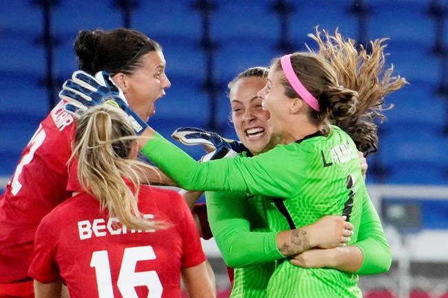 Christine Sinclair, left, celebrates with teammates as Canada celebrates after defeating Sweden in the penalty shoot-out in the women's soccer final during the summer Tokyo Olympics in Yokohama, Japan on Friday, August 6, 2021. THE CANADIAN PRESS/Frank Gunn