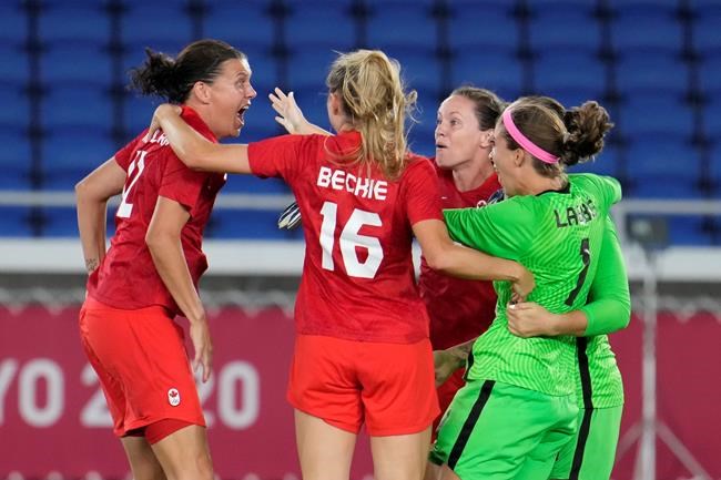 Christine Sinclair, left, celebrates with teammates as Canada celebrates after defeating Sweden in the penalty shoot-out in the women's soccer final during the summer Tokyo Olympics in Yokohama, Japan on Friday, August 6, 2021. THE CANADIAN PRESS/Frank Gunn