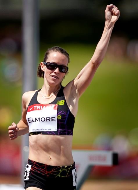 Malindi Elmore, from Kelowna, B.C., celebrates winning in the women's 1,500-metre event at the Canadian Track and Field Championships in Calgary, Alta., Friday, June 29, 2012. Elmore will represent Canada at the London 2012 Olympics. THE CANADIAN PRESS/Jeff McIntosh