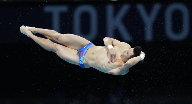 Cao Yuan of China competes in men's diving 10m platform semifinal at the Tokyo Aquatics Centre at the 2020 Summer Olympics, Saturday, Aug. 7, 2021, in Tokyo, Japan. (AP Photo/Dmitri Lovetsky)