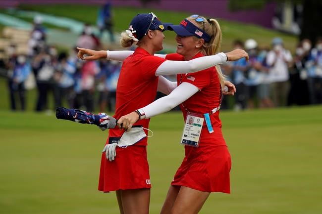 Nelly Korda, of the United States, left, celebrates with her sister Jessica Korda after winning the gold medal on the 18th hole during the final round of the women's golf event at the 2020 Summer Olympics.during the final round of the women's golf event at the 2020 Summer Olympics, Saturday, Aug. 7, 2021, at the Kasumigaseki Country Club in Kawagoe, Japan. (AP Photo/Matt York)