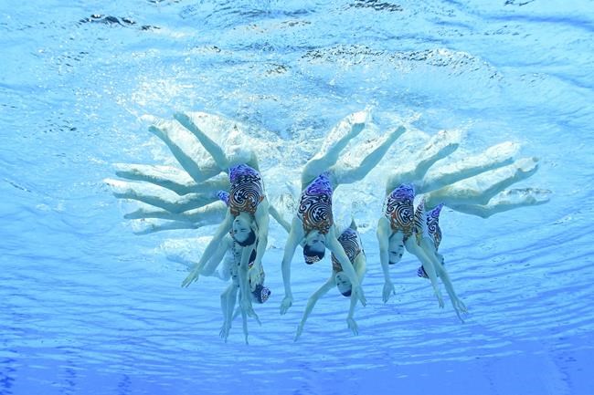 The China artistic swimming team competes during the team free routine final at the 2020 Summer Olympics, Saturday, Aug. 7, 2021, in Tokyo, Japan. (AP Photo/Jeff Roberson)