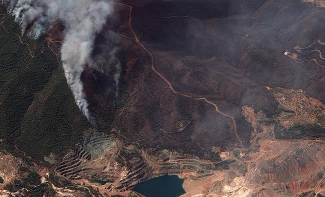 In this satellite image provided by Maxar Technologies wildfires burn north of Athens, Greece on the island of Evia, where some of the most destructive and active fires continue to burn, Sunday, Aug. 8, 2021. Pillars of billowing smoke and ash turned the sky orange and blocked out the sun above Greece's second-largest island Sunday as a days-old wildfire devoured pristine forests and encroached on villages, triggering more evacuation alerts. (Satellite image ©2021 Maxar Technologies via AP)