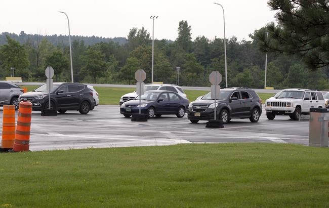 Cars line up at the border crossing at Lacolle, Que., south of Montreal, Monday, August 9, 2021 as the border re-opens to fully vaccinated Americans.THE CANADIAN PRESS/Ryan Remiorz