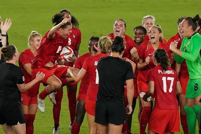 Canada players including Christine Sinclair (holding ball) celebrate their win against Sweden during the women's soccer gold medal game at the Tokyo Olympics in Yokohama, Japan on Friday, Aug. 6, 2021. Sinclair was substituted in the second half of the gold-medal match, meaning she had to watch the penalty shootout that decided the game from the sidelines. THE CANADIAN PRESS/Adrian Wyld