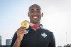 Canadian decathlete Damian Warner shows off his gold medal during a homecoming event to celebrate Canadian Olympians who participated in the Tokyo 2020 Olympics, at CF Sherway Gardens, Toronto, Thursday August 12, 2021.THE CANADIAN PRESS/Eduardo Lima