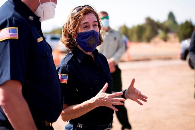 FILE - In this June 28, 2021, file photo Oregon Gov. Kate Brown visits the Bly Fire Camp, on the southern edge of the Bootleg Fire, in Klamath County, Ore. Oregon's governor said Friday, Aug. 13, 2021 she will send up to 1,500 National Guard troops to hospitals around the state to support healthcare workers as the COVID-19 surges amid the rapid spread of the Delta variant. The first group of 500 Guard members will be deployed next Friday to serve as material and equipment runners in the most stricken hospitals and to help with COVID-19 testing. (Arden Barnes/The Herald And News via AP, File)