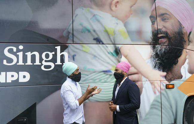 NDP Leader Jagmeet Singh chats with his younger brother Gurratan during a campaign stop in Brampton, Ont., on Monday, August 16, 2021. THE CANADIAN PRESS/Paul Chiasson