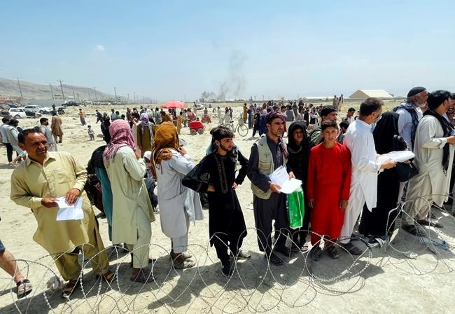 Hundreds of people gather outside the international airport in Kabul, Afghanistan, Tuesday, Aug. 17, 2021. Justin Trudeau is blaming Taliban checkpoints rather than government bureaucracy and delays for what many see as the slow pace of Canada’s effort to save former Afghan interpreters and their families. The prime minister and Liberal leader made the comments during an election campaign event in Vancouver today as fears and frustrations mount over the fate of hundreds of Afghans at risk of Taliban retribution for their links to Canada. THE CANADIAN PRESS/AP Photo