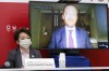 FILE - In this June 21, 2021, file photo, Tokyo 2020 President Seiko Hashimoto listens to International Paralympic Committee (IPC) President Andrew Parson, on a screen, during a five-party online meeting at Harumi Island Triton Square Tower Y in Tokyo. The opening next week of the Paralympic Games in Tokyo is being used as a stage to launch a human rights movement aimed at the world’s 1.2 billion people with disabilities.(Rodrigo Reyes Marin/Pool Photo via AP, File)