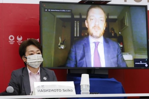 FILE - In this June 21, 2021, file photo, Tokyo 2020 President Seiko Hashimoto listens to International Paralympic Committee (IPC) President Andrew Parson, on a screen, during a five-party online meeting at Harumi Island Triton Square Tower Y in Tokyo. The opening next week of the Paralympic Games in Tokyo is being used as a stage to launch a human rights movement aimed at the world’s 1.2 billion people with disabilities.(Rodrigo Reyes Marin/Pool Photo via AP, File)