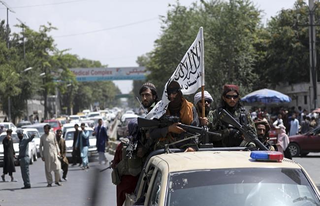 Taliban fighters display their flag while on patrol in Kabul, Afghanistan, Thursday, Aug. 19, 2021. The Taliban celebrated Afghanistan's Independence Day on Thursday by declaring they beat the United States, but challenges to their rule ranging from running a country severely short on cash and bureaucrats to potentially facing an armed opposition began to emerge. (AP Photo/Rahmat Gul)