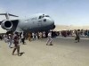 FILE - In this Apug. 16, 2021 file photo, hundreds of people run alongside a U.S. Air Force C-17 transport plane as it moves down a runway of the international airport, in Kabul, Afghanistan. Twin tragedies on opposite sides of the world are piling misery on people that have seen far more than their share. In Afghanistan, a group of gunmen known for sadistic tyranny rocketed back into power after 20 years as Western and Afghan leaders walked away with a sad shrug.(Verified UGC via AP, File)