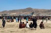 Hundreds of people gather near a U.S. Air Force C-17 transport plane at the perimeter of the international airport in Kabul, Afghanistan, Monday, Aug. 16, 2021. THE CANADIAN PRESS/AP, Shekib Rahmani