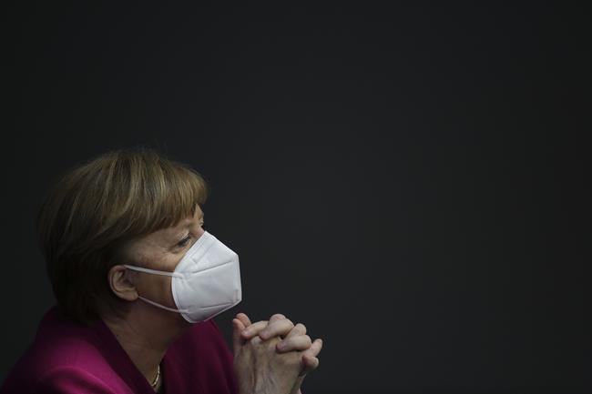 In this Thursday, March 25, 2021 file photo, German Chancellor Angela Merkel attends a session of the German parliament Bundestag ahead of an European Union summit at the Reichstag building in Berlin, Germany. Merkel pointed to her government's drive to improve Germany's public finances, which enabled it to stop running up new debt from 2014 until the coronavirus pandemic pushed it into huge rescue packages. (AP Photo/Markus Schreiber, file)