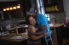 Freddie De Los Santos kisses his wife, Jeanette, at their home in Hopewell Junction, N.Y., on Wednesday, Aug. 19, 2021. “I function pretty well right now, but it hasn’t been easy,” he says. He credits psychotherapy, along with a deep Christian faith, a very patient family, a love for painting, and cycling. (AP Photo/Emilio Morenatti)