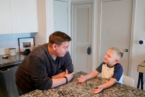 Associated Press investigative reporter James LaPorta and his son Joel, 5, sit at their home, Tuesday, Sept. 7, 2021, in Boca Raton, Fla. LaPorta recalls a boy he encountered in Afghanistan back in 2013 while serving as a Marine. (AP Photo/Marta Lavandier)