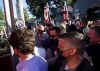 A man, top right, throws gravel at Liberal leader Justin Trudeau, left, as the RCMP security detail provide protection, while protesters shout at a local microbrewery during the Canadian federal election campaign in London Ont., on Monday, September 6, 2021. THE CANADIAN PRESS/Nathan Denette