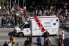 An ambulance passes through a crowd of people protesting COVID-19 vaccine passports and mandatory vaccinations for healthcare workers, in Vancouver, B.C., Wednesday, Sept. 1, 2021. THE CANADIAN PRESS/Darryl Dyck