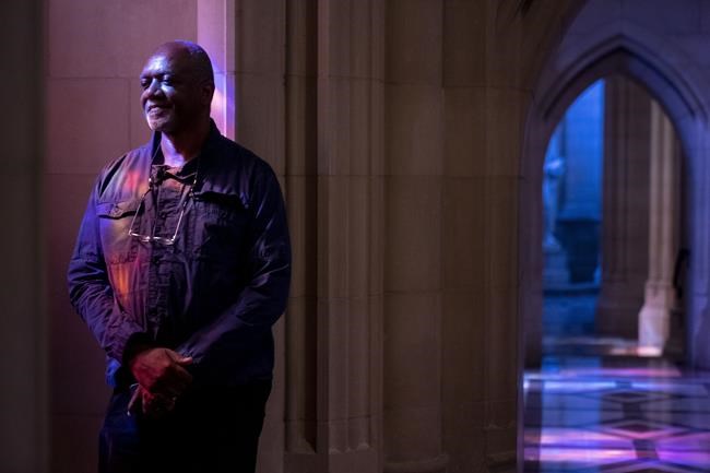 Artist Kerry James Marshall poses for a portrait in the National Cathedral after being selected to design a replacement of former confederate-themed stained glass windows that were taken down in 2017, in Washington, Thursday, Sept. 23, 2021. (AP Photo/Andrew Harnik)