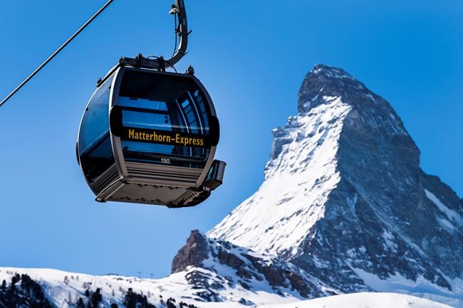 FILE - In this Wednesday, March 18, 2020 file photo, a view of a 'Matterhorn-Express' gondola lift in front of Matterhorn mountain in the Zermatt ski resort, in Zermatt, Switzerland. A downhill race starting in Switzerland and ending in Italy will be added to Alpine skiing’s World Cup program as soon as next year, it was announced Friday, Oct. 1, 2021. The International Ski Federation has confirmed the plan. Men’s and women’s races beneath the iconic Matterhorn mountain near upscale Zermatt are likely in November 2022. (Jean-Christophe Bott/Keystone via AP, File)