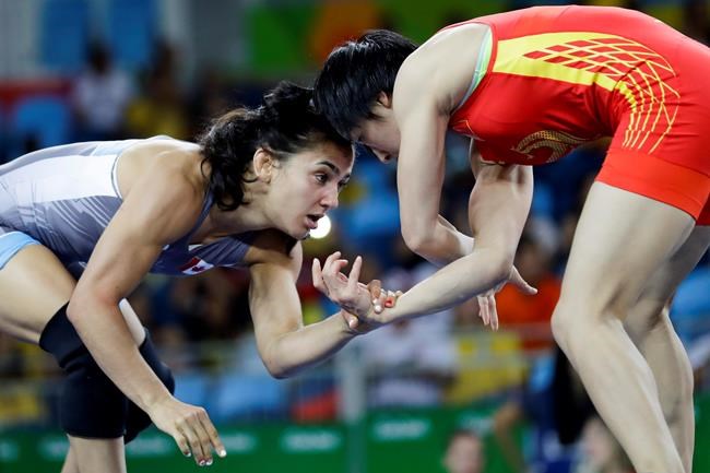 Canada's Jasmine Mian, blue, competes against China's Sun Yanan during the women's 48-kg freestyle wrestling competition at the 2016 Summer Olympics in Rio de Janeiro, Brazil, Wednesday, Aug. 17, 2016. Newly elected Calgary city councillor Jasmine Mian joins several Olympic and Paralympic athletes who have run for political office in Canada and won in recent years. THE CANADIAN PRESS/AP, Markus Schreiber