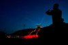 A reporter uses his smartphone to film a light show at the National Ski Jumping Centre, one of the venues for Beijing 2022 Olympic and Paralympic Winter Games, during a media tour in Zhangjiakou in northwestern China's Hebei province on Wednesday, July 14, 2021. Canada's Olympic and Paralympic athletes must be vaccinated to compete at the 2022 Winter Games in Beijing. THE CANADIAN PRESS/AP/Andy Wong