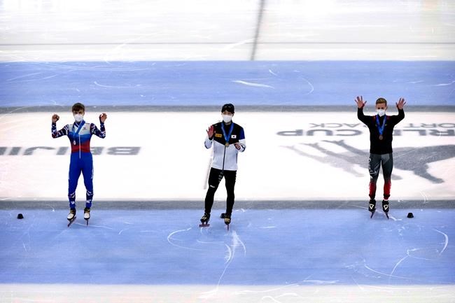 From left, silver medalist Semen Elistratov of Russia, gold medalist Hwang Dae-hon of South Korea, and bronze medalist Pascal Dion of Canada stand during the medal ceremony for the men's 1000m at the ISU World Cup Short Track speed skating competition, a test event for the 2022 Winter Olympics, at the Capital Indoor Stadium in Beijing, Sunday, Oct. 24, 2021. THE CANADIAN PRESS/AP, Mark Schiefelbein