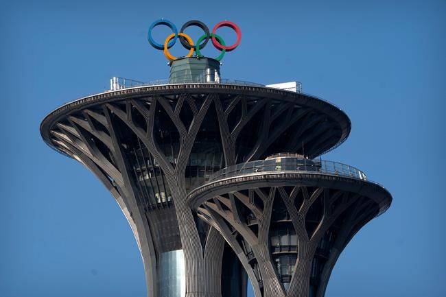 The Olympic rings are visible atop the Olympic Tower in Beijing, Tuesday, Feb. 2, 2021. With the dust barely settled on the recent Summer Games, a reminder came Wednesday that the next Olympiad is fast approaching. THE CANADIAN PRESS/AP, Mark Schiefelbein