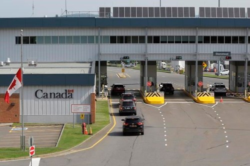 Cars with U.S. license plates enter Canada at the Stanstead, Quebec, border crossing as seen from Derby Line, Vt., Monday Aug. 9, 2021. THE CANADIAN PRESS/AP-Wilson Ring