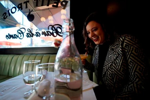 Erin Tridle holds a video chat with her boyfriend Jordan Commarrieu living in Paris from their favorite French restaurant 