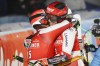 Austria's Christian Hirschbuehl, left, winner of an alpine ski, men's World Cup parallel event, hugs second-placed Austria's Dominik Raschner, in Lech/Zuers, Austria, Sunday, Nov. 14, 2021. (AP Photo/Marco Trovati)