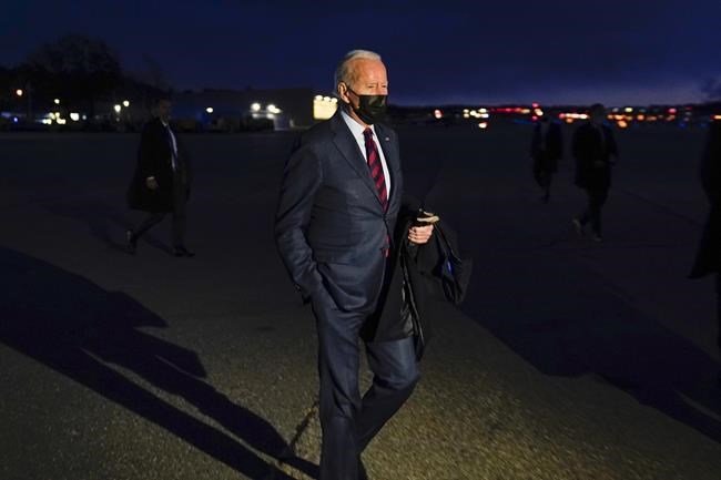 President Joe Biden walks over to speak to reporters as he prepares to depart Manchester-Boston Regional Airport, Tuesday, Nov. 16, 2021, in Manchester, N.H. (AP Photo/Evan Vucci)