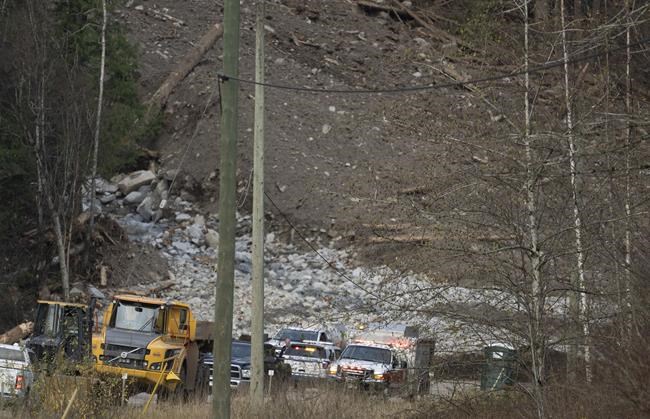 Emergency vehicles and tractors are seen at the base of a mudslide on Highway 7 west of Agassiz, B.C., Wednesday, Nov. 17, 2021. THE CANADIAN PRESS/Jonathan Hayward