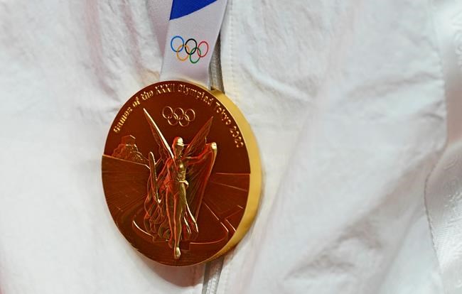 The gold medal of United States's Diana Taurasi hangs as she stands on the podium during the medal ceremony for women's basketball at the 2020 Summer Olympics, in Saitama, Japan, Sunday, Aug. 8, 2021. THE CANADIAN PRESS/AP-Charlie Neibergall
