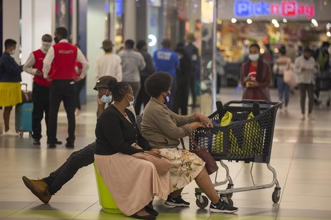 People shop in a mall, in Johannesburg, South Africa, Friday Nov. 26, 2021. Advisers to the World Health Organization are holding a special session Friday to flesh out information about a worrying new variant of the coronavirus that has emerged in South Africa, though its impact on COVID-19 vaccines may not be known for weeks. (AP Photo/Denis Farrell)